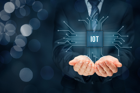 Internet of things (IoT) concept. Businessman offer IoT products and solutions. Abstract chip with text IoT connected with abstract devices represented by points.の写真素材