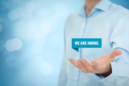 Headhunter (recruiter) hold virtual label with text we are hiring - human resources (HR) concept.の写真素材