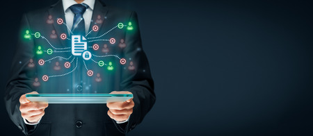 Corporate data management system (DMS) and document management system with privacy theme concept. Businessman or programmer with tablet and scheme with protected document connected with users, access rights symbolized by key.の写真素材