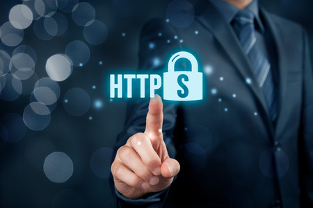 HTTPS - secured internet concept. Businessman or programmer click on https text and padlock symbol.の写真素材