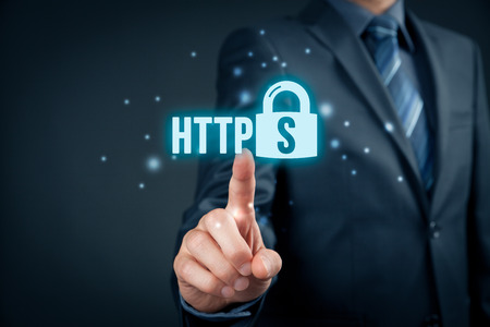 HTTPS - secured internet concept. Businessman or programmer click on https text and padlock symbol.の写真素材