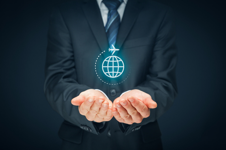 Travel insurance and business travel concepts. Insurance agent or businessman with protective gesture and icon of plane and globe.の写真素材