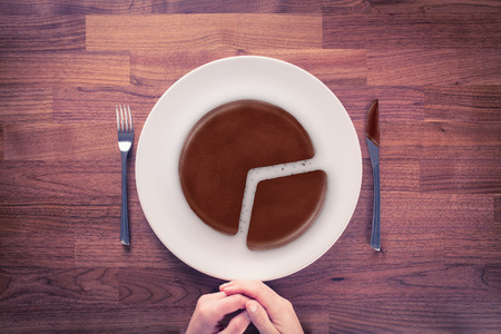 Market share - marketing business concept. Business visual metaphor - businessman with plate and pie chart with imitation of a chocolate cake.の写真素材