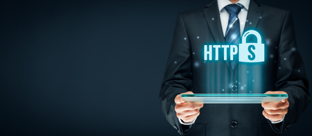 HTTPS - secured internet concept. Businessman or programmer with tablet and https text and padlock symbol.の写真素材
