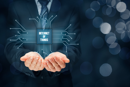 Internet of things (IoT) concept. Businessman offer Internet of Things products and solutions. Abstract chip with text Internet of Things connected with abstract devices represented by points.の写真素材