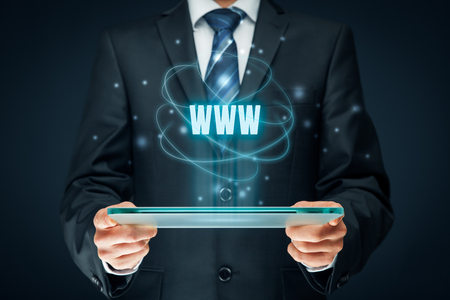 World wide web (www) - internet websites and SEO concepts. Businessman hold futuristic tablet with head-up display and text www.の写真素材
