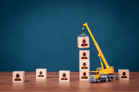 Build team, hire and recruitment concepts. Recruiter represented by crane complete team.の写真素材