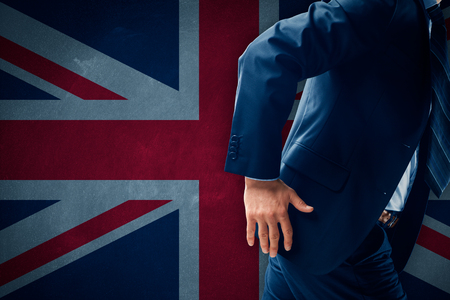 Brexit concept. Businessman (financier, bank employee, bank employee, CEO, manager) run away (escape) from Great Britain.の写真素材