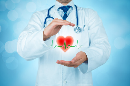 Protect health (healthcare) and heart problems prevention (cardiology) concept. Cardiologist or general practitioner doctor with protective gesture and symbol of heart and ECG heartbeat. Medical insurance concept.の写真素材