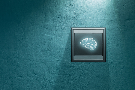 Turn on creativity and brainstorming concepts. Switch on wall with symbol of brain.の写真素材