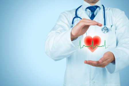 Protect health (healthcare) and heart problems prevention (cardiology) concept. Cardiologist or general practitioner doctor with protective gesture and symbol of heart and ECG heartbeat. Medical insurance concept.の写真素材