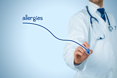 Decrease allergies concept. Doctor (medical practitioner) draw decreasing graph of allergies.の写真素材