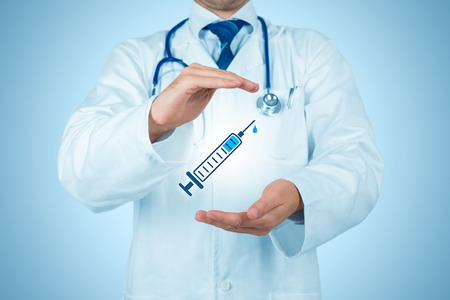 Immunization coverage concept. Practitioner doctor with protective gesture and icon of the hypodermic needle.の写真素材