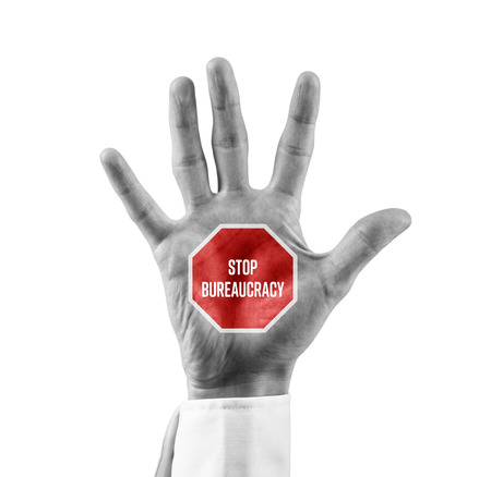 Stop bureaucracy concept. Businessman hand with stop street sign and text Stop Bureaucracy.の写真素材