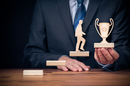 Motivation, personal development, personal and career growth, progress and potential concepts. Coach (human resources officer, manager, mentor) motivate employee to growth with cup for a winner.の写真素材