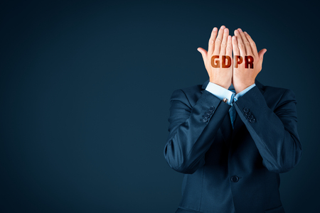 GDPR and personal information protection concept. Businessman, customer or internet user protect his face with hands with text GDPR.の写真素材