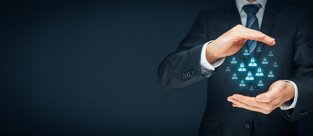 GDPR (general data protection regulation) concept. Businessman or IT technologist with protective gesture and icons of people with lock instead of head.の写真素材