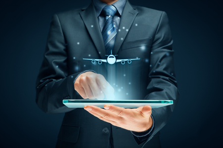 Air ticket booking on digital tablet app or online travel insurance concepts. Person with digital tablet and symbol of a plane.の写真素材