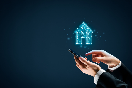 Smart home, intelligent house, and home automation app concept. Smart house icon with pcb design and person with smart phone.の写真素材