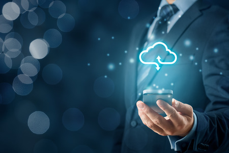 Cloud computing concept - connect smart phone to cloud. Businessman or information technologist with cloud computing icon and smart phone.の写真素材