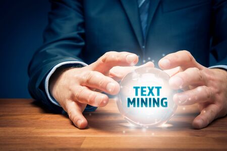 Businessman look into the crystal ball to text mining analysis.の写真素材