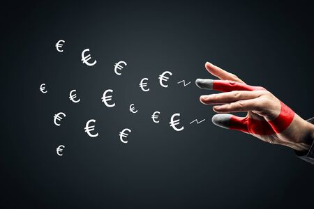 Financial success concept - magnet for money euro concept. Hand of businessman attract symbols of euro.の写真素材