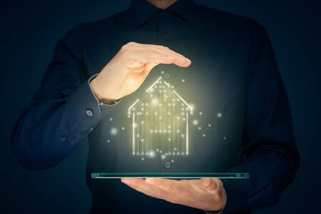 Smart home, intelligent house, and home automation app security concept. Smart house icon with pcb design, tablet and businessman with protective insurance gesture.の写真素材