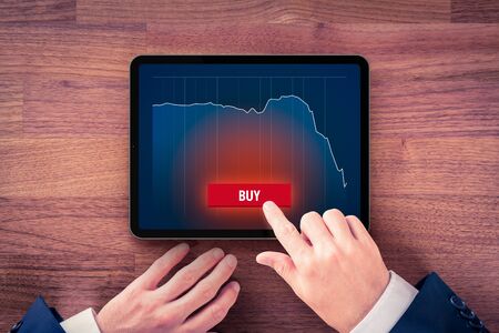 Investment opportunity to buy in crisis time concept. Investor buy stock, commodities, gold and another on digital tablet.の写真素材
