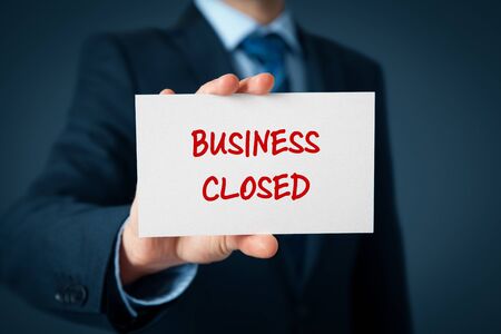 Business closed bankruptcy concept. Businessman with card and text business closed.の写真素材