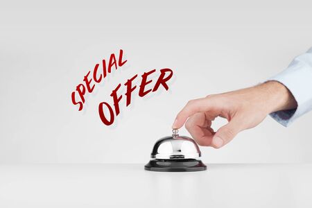 Special offer marketing concept. Marketer beats alarm (press ring bell) to point out special marketing offer.の写真素材