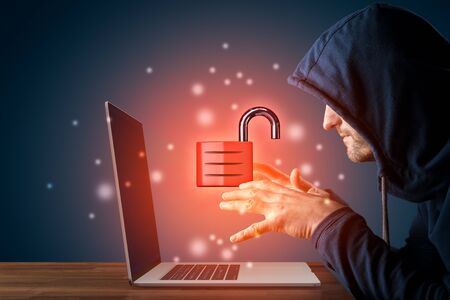 Hacker reach for unprotected computer. Password and data leakage and cybersecurity concept. Notebook with symbol of open padlock and hacker.の写真素材