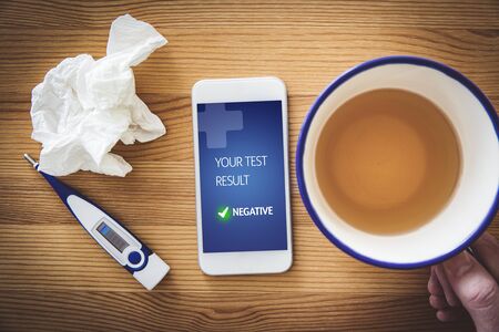 Negative medical test notification on recovered patient smart phone. Use of modern technologies in medicine.の写真素材