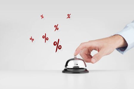 Sale marketing concept. Marketing specialist beats alarm (press ring bell) to advertise sale campaign.の写真素材