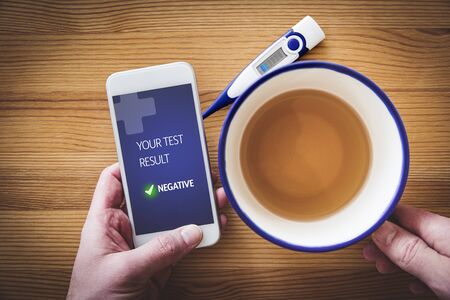 Negative medical test notification on recovered patient smart phone. Use of modern technologies in medicine.の写真素材