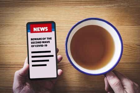 Preparing for a second wave of covid-19 in business news. Businessman read how to prepare company for a second wave of coronavirus covid-19. Post-covid-19 era in business and investment concept.の写真素材