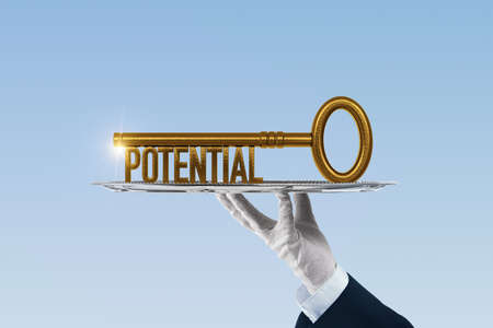 Coach has a key to unlock potential - motivation concept. Coach (manager, mentor, HR specialist) holding silver platter (salver, tray) with key with text potential.の写真素材