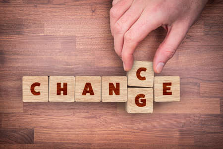 Change is your chance motivational concept. Mentor motivate to change and to take opportunity in post covid-19 era after pandemic. Wooden cubes with text change transformed to the word change, flat lay top down view design.の写真素材