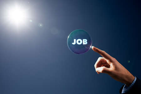 Catch dream job concept. Hand with soap bubble (symbol of dream) with text job inside. Crisis after covis-19 pandemic is opportunity to change the job.の写真素材