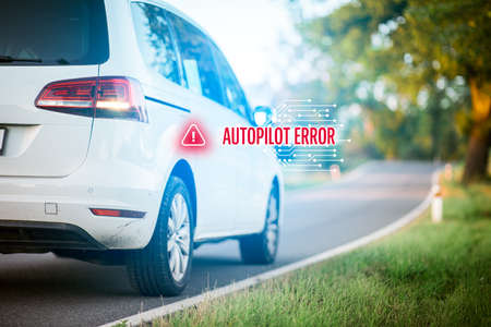 Car autopilot software error concept. Immobile intelligent autonomous car due to software error stands at side of the road. Software failure and its impact to autonomous vehicle concept.の写真素材