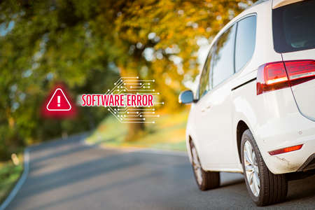 Car software error concept. Immobile intelligent car due to software error stands at side of the road. Software failure and its impact to autonomous vehicle concept.の写真素材
