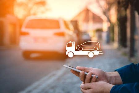 Search assistance service (wrecking towing breakdown service) on smart phone. Person with smart...