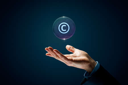 Copyright, patents and intellectual property protection law and rights. Hand with soap bubble (symbol of dream) with symbol of the copyright inside.の写真素材