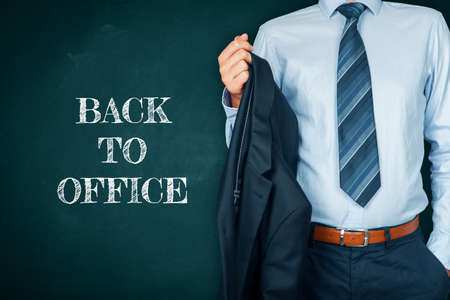 Back to office after end of covid-19 lockdown and quarantine concept. Worker with business suit and text back to office.の写真素材