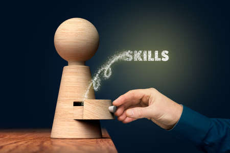 Discover your skills concept. Coach (manager, mentor) open drawer from wooden figurine, there is hidden skills going out.の写真素材
