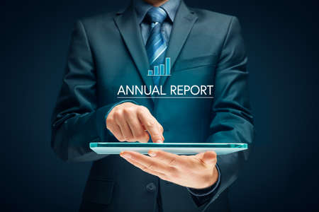 Annual report concept on digital tablet. Financier, accountant or investor read company annual report on digital tablet.の写真素材