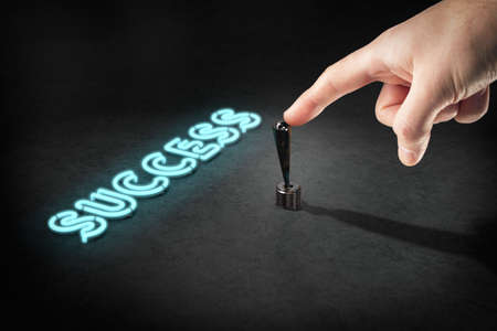 Switch your mind to success concept. Detail of hand, toggle switch and neon light text success.の写真素材