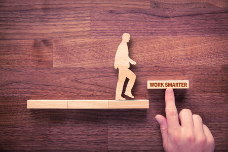 Work smarter motivation concept. Personal development, boost productivity and efficiency concept with wooden pieces. Coach (manager, mentor) motivate to work smarter.の写真素材