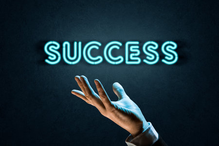 Success is in your hand. Concept with neon light text success and detail of hand.の写真素材