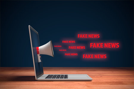 Fake news and their impact to the public and policy concept. Notebook with megaphone and text fake news. Contamination of public space with fake news are part of hybrid war.の写真素材