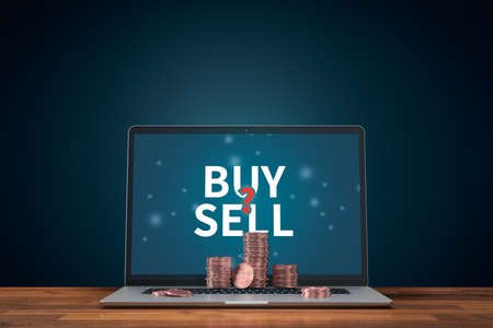 Bitcoin cryptocurrency buy or sell investment concept. Bitcoin coins on notebook, buy or sell question on LCD screen.の写真素材